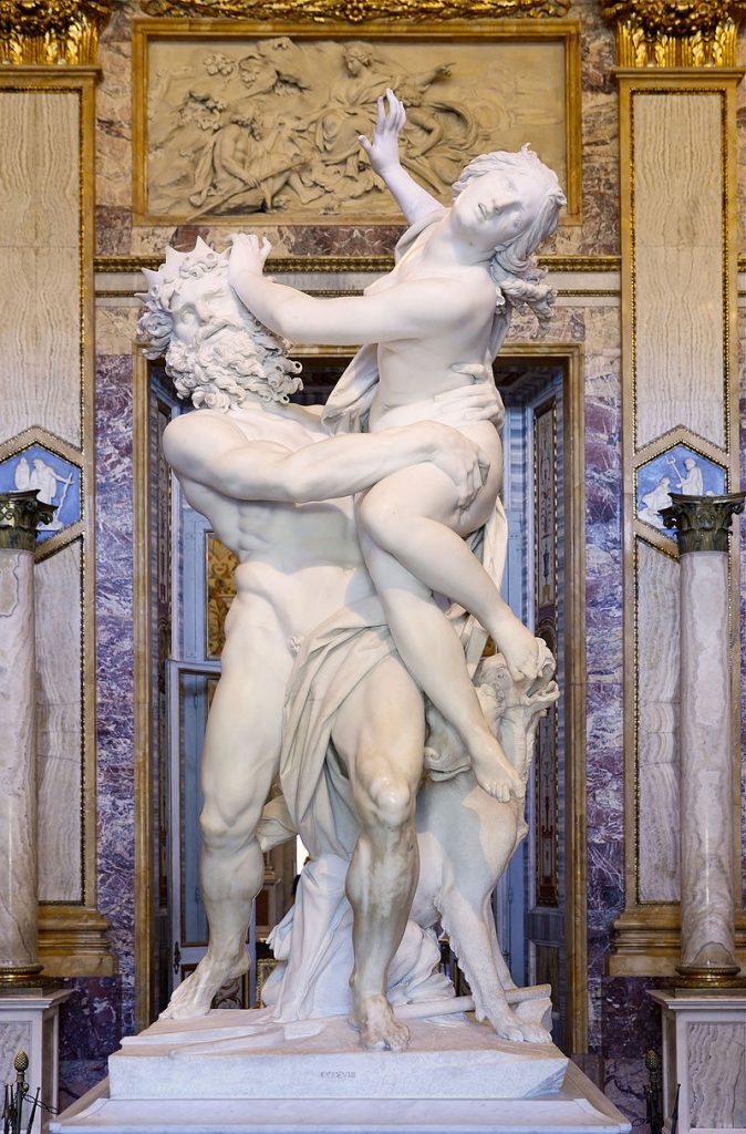 A picture of a white marble sculpture by Bernini, depicting a muscular man with long curly hair and beard holding a woman. He is gripping the woman with his left hand around her waist and his right hand around her left thigh; her hip is at his chest height. She has her right arm raised behind her, her head is tilted away from the man but facing forwards, and she is pushing the man's head away from her with her left hand.